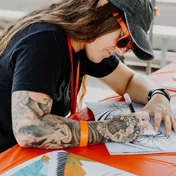 Tiffany Lehman drawing during an outdoor creative experience