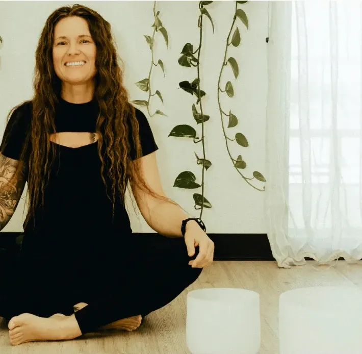 Tiffany Lehman smiling in a bright wellness studio